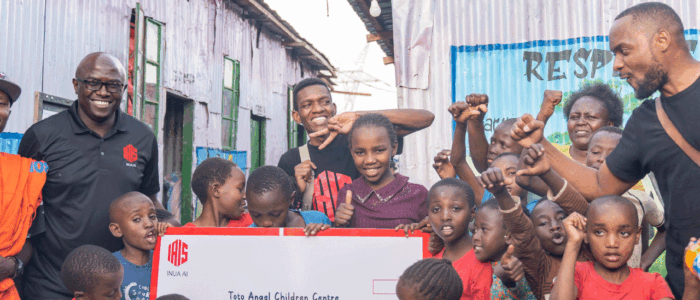 An image showing Humphrey Muchuma talking to people at toto children's home