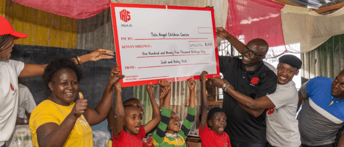 An image showing Humphrey Muchuma talking to people at toto children's home