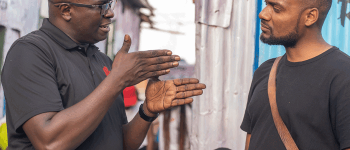 An image showing Humphrey Muchuma talking to people at toto children's home